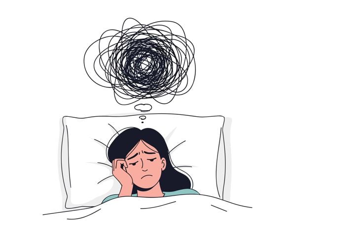 Woman lying in bed at night with a large tangled scribble cloud over her head symbolizing insomnia