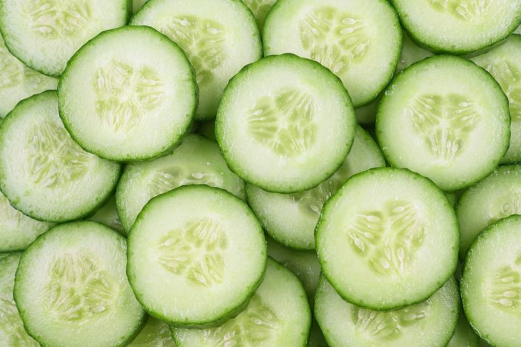 Cucumber background. Round cucumber slices, top view.