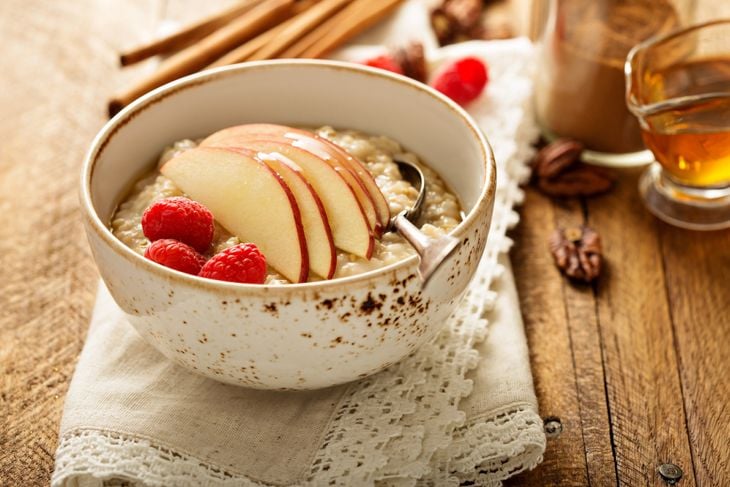 Homemade oatmeal for breakfast with apple, cinnamon and honey