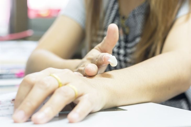 A long -haired woman's medicine massage arm in the office.