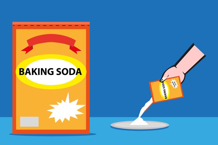 Baking Soda box and poured on a plate by a hand