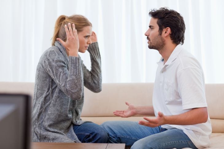 Young couple arguing in their living room