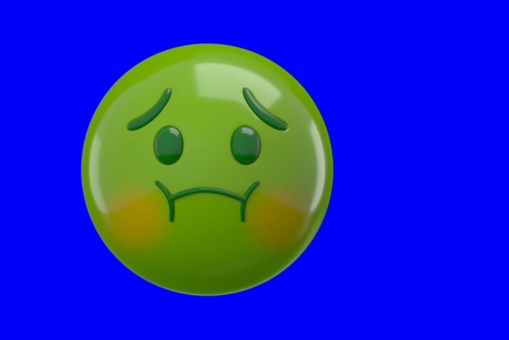 Green sick emoji with a queasy expression on a blue