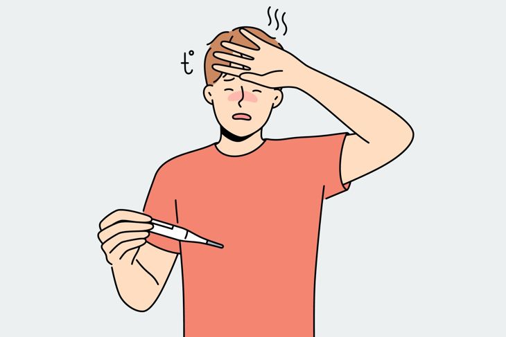Unwell man suffer from influenza or fever measure high temperature on thermometer
