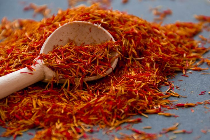 Saffron in a spoon on a dark background