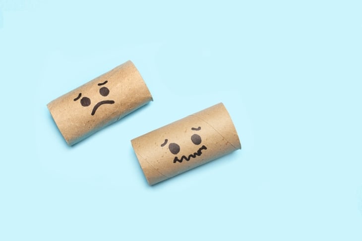 Cardboard center of a toilet paper rolls without paper with and sad faces