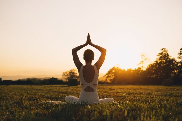 Young woman practicing yoga on nature