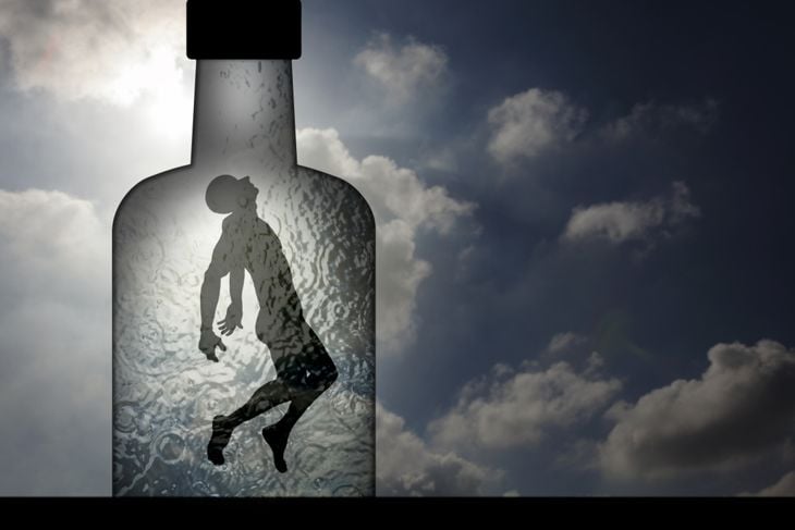 Silhouette of a man trapped in a liquor bottle