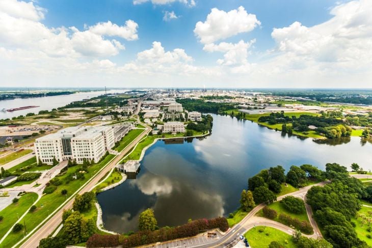 aerial of baton Rouge with Missisippi river and oil refineries at the horizon