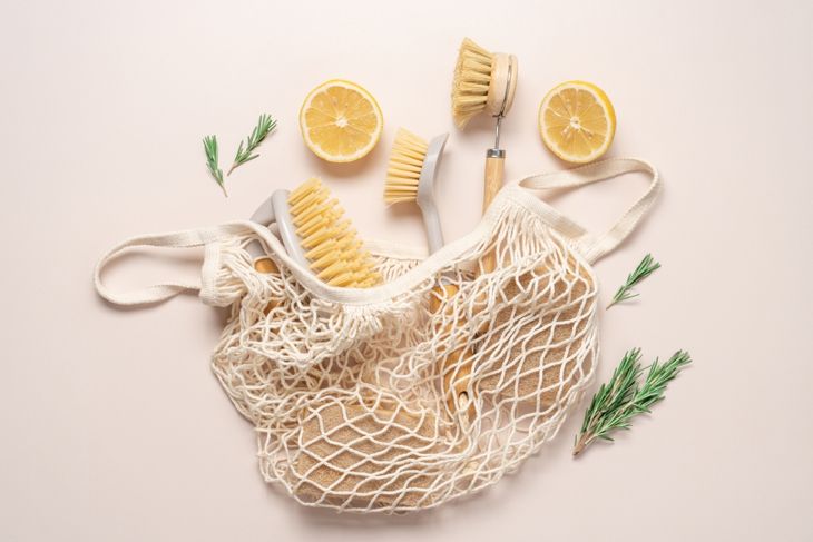 Zero waste home cleaning supplies, lemon and rosemary for making sustainable cleaning essentials on beige background. 