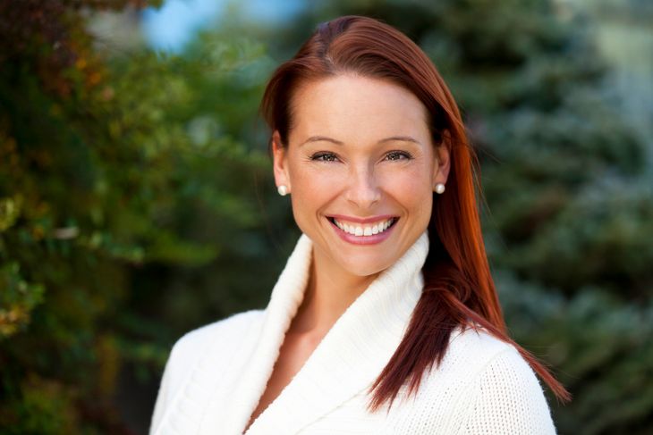 Woman Smiling At The Camera At The Park