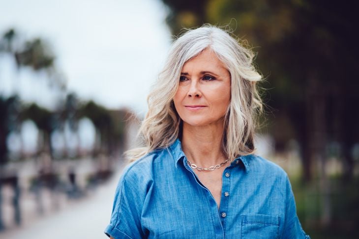 Beautiful fashionable mature woman with gray hair outdoors in the city
