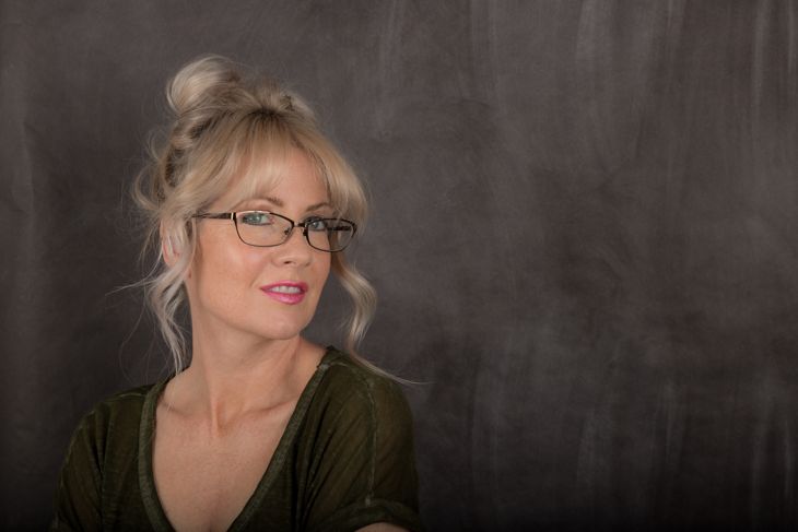 Woman With Blonde Bun, Bangs, and Glasses