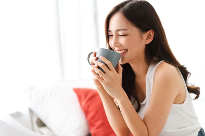 smiling alert woman drinking tea
