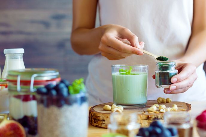 woman making a healthy dish to help with good digestion