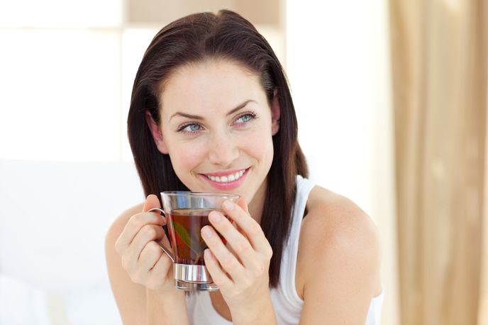 happy looking woman drinking tea