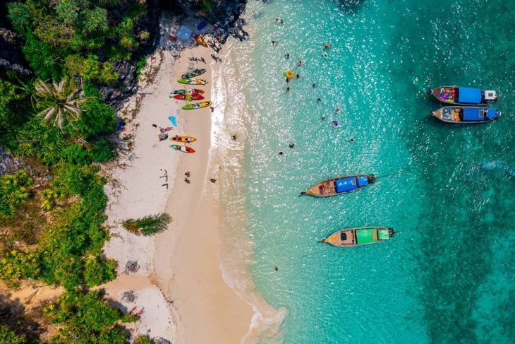 Nui beach and long tail boat in Phi Phi Don island, Krabi, aerial top view. Concept beauty nature of Thailand, travel Phuket.