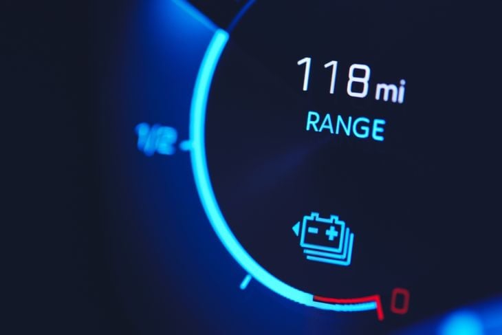 Close-in shot of electric car battery range gauge in blue