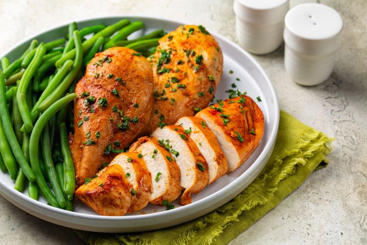 Oven baked boneless chicken breast made with paprika and parsley, green beans
