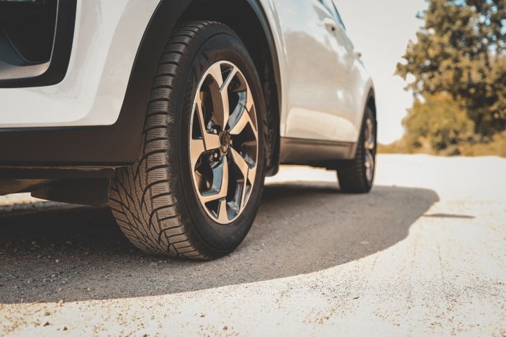 Car wheels close up on a background of asphalt