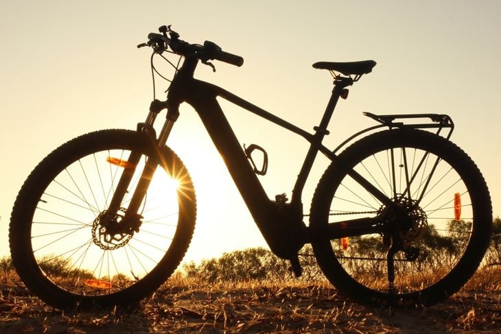 Backlit ebike in silhouette at sunset