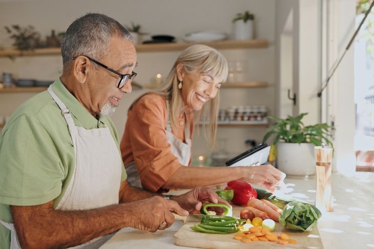 senior man and woman with ingredients at home for meal prep