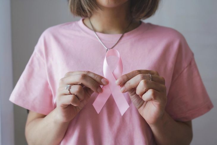 Woman hold pink ribbon breast cancer awareness