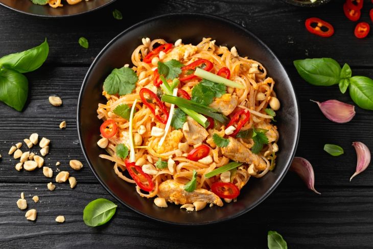 Chicken Pad Thai with eggs, bean sprouts, peanuts and spring onion