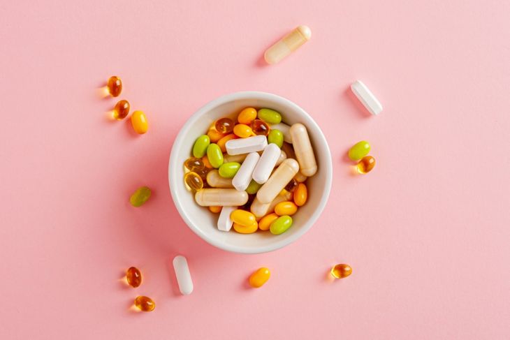 Colorful Dietary Supplements on a pink background
