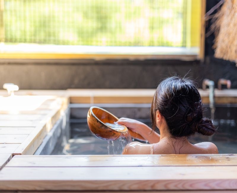 Woman enjoy the onsen in bathtub at resort