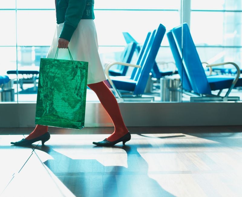 woman holding shopping bag at the airport