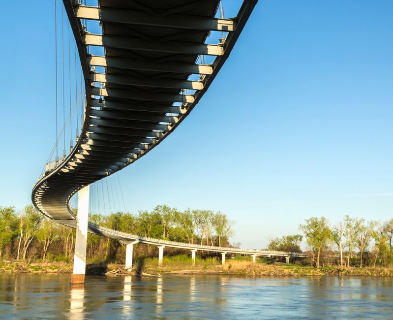 The Bob Kerrey Pedestrian Bridge is a curvaceous 3,000-foot footbridge across the Missouri River linking Council Bluffs, Iowa, and Omaha, Nebraska.