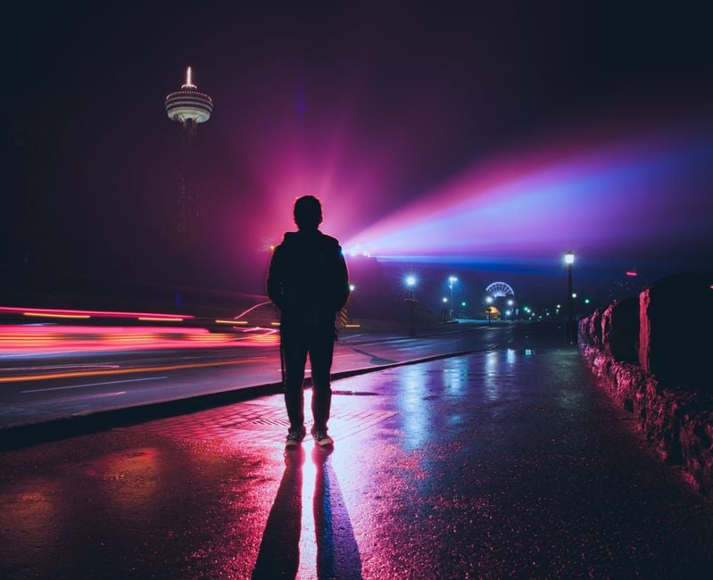 Silhouette of man with spectacular colorful light source at background, long exposure photo.