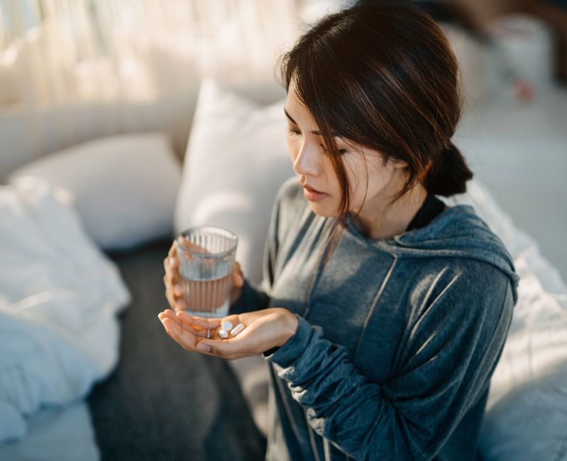 woman taking pills
