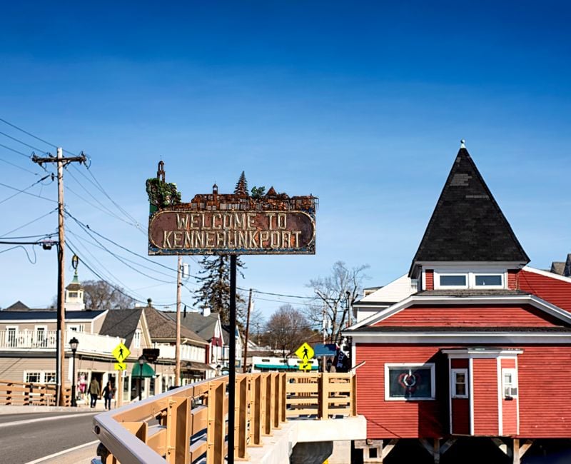The Kennebunkport sign located on a bridge crossing the Batson River on a cold sunny winter day in New England.