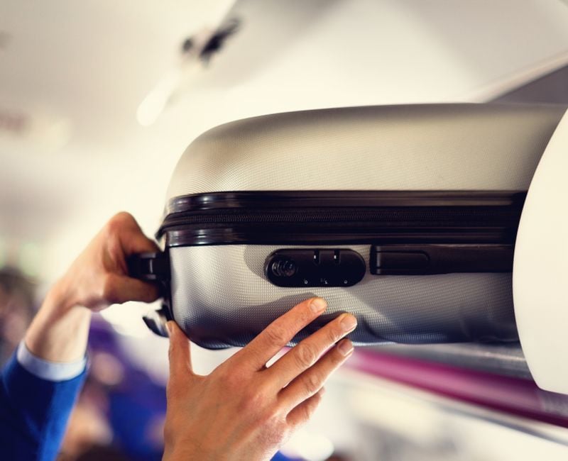 Hand-luggage compartment with suitcases in airplane