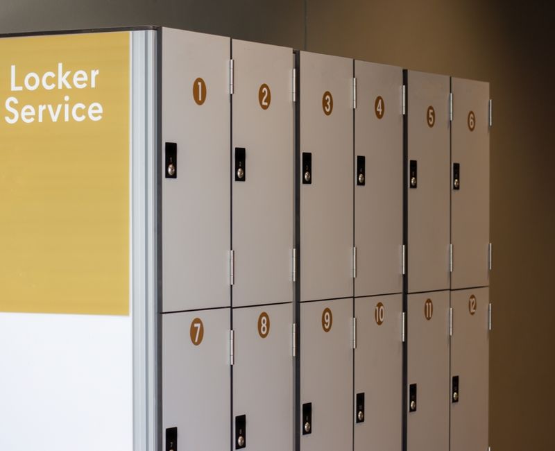 A row of lockers with a sign that says locker service. The lockers are numbered from 1 to 12
