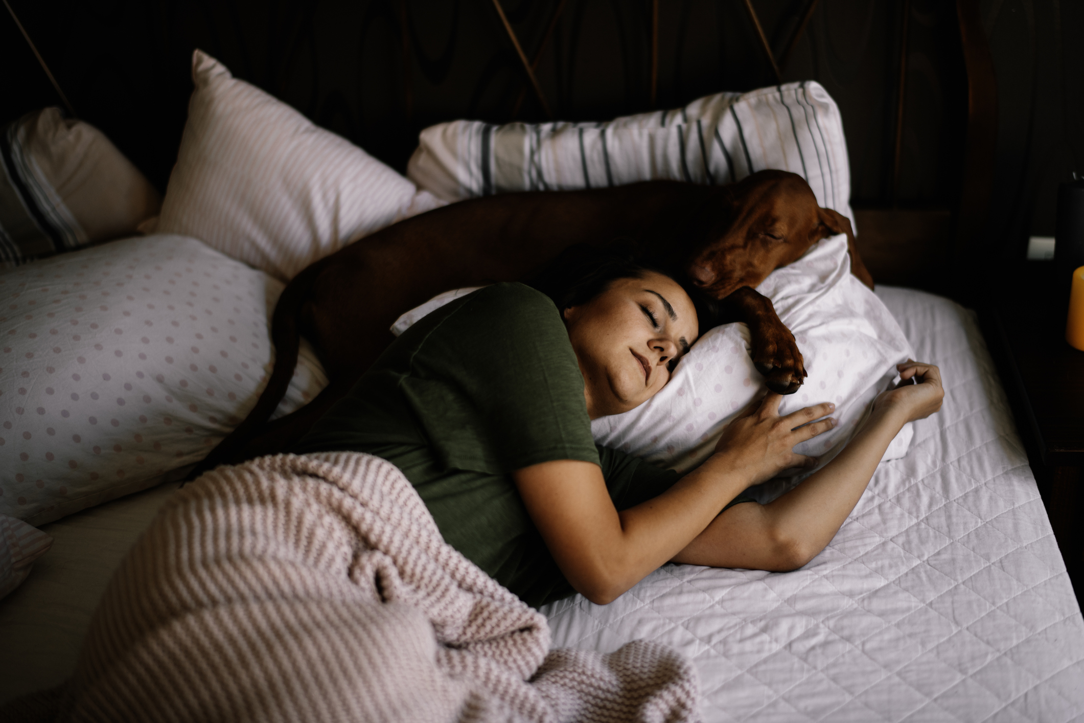 woman sleeping with dog