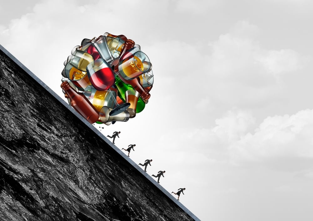 Drinking Health Danger concept as a falling boulder made of beer wine and spirits alcoholic